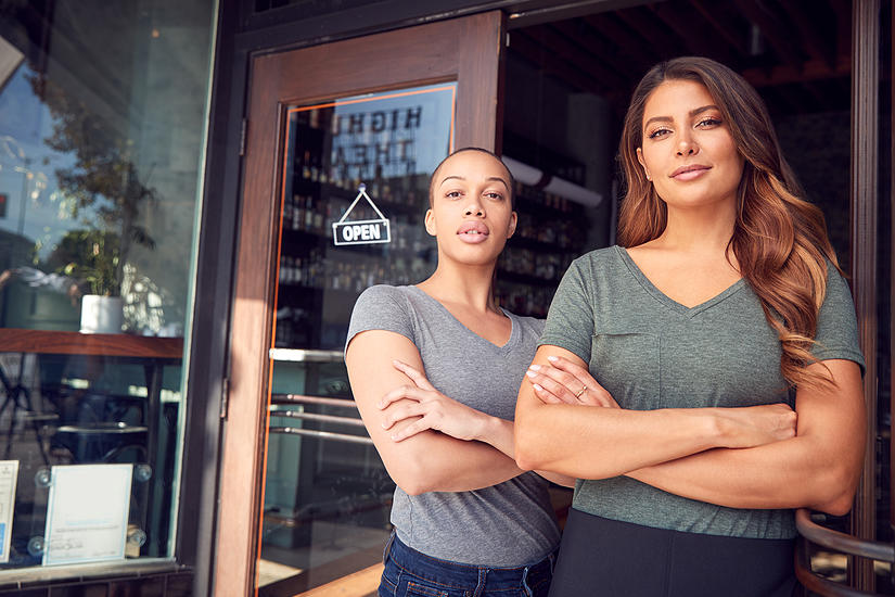 Two women standing in front of coffee shop