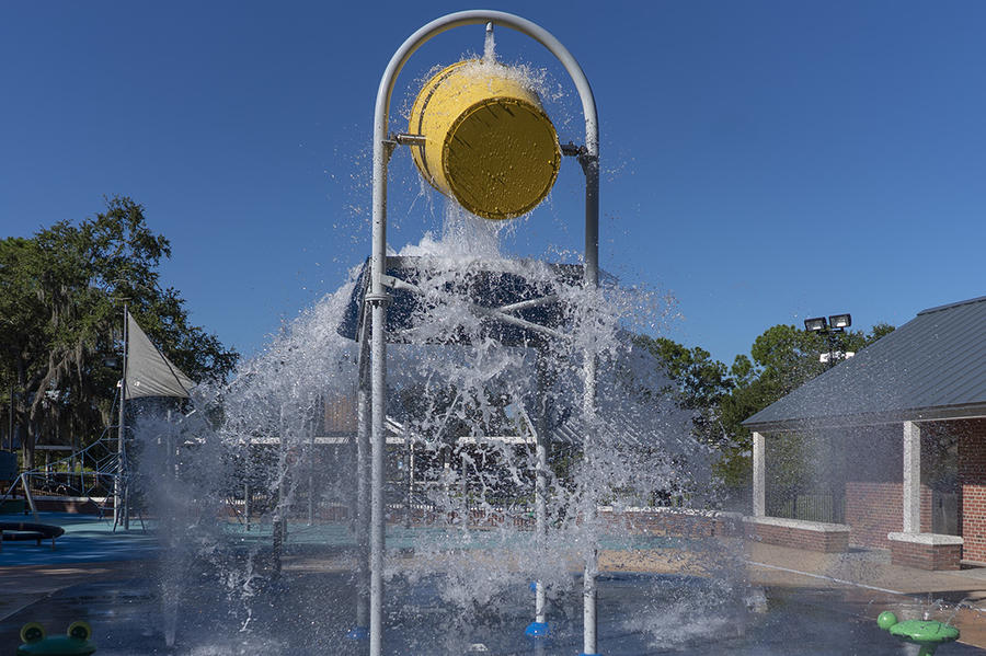 View of bucket pouring water on splash pad